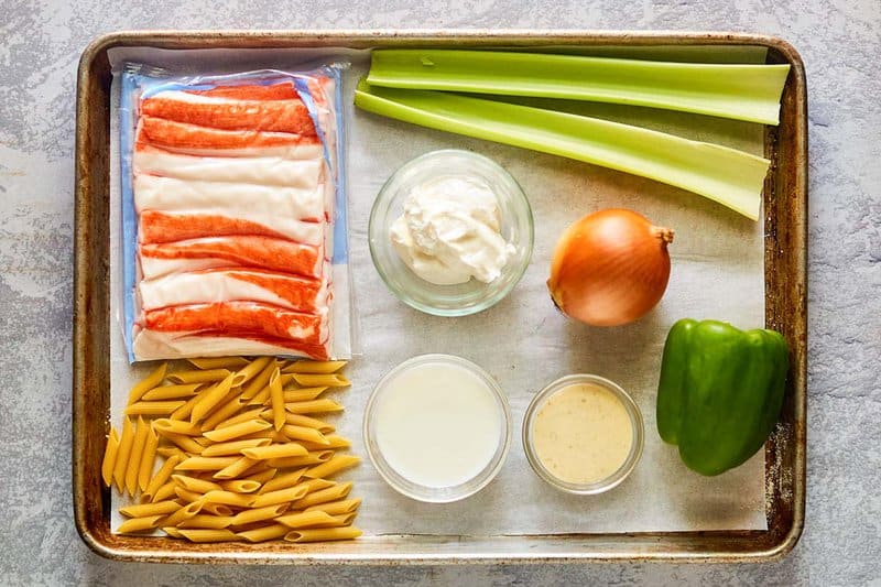 Seafood pasta salad ingredients on a tray.