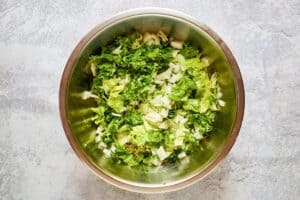 Chopped lettuce for a traditional Greek Salad in a large bowl.