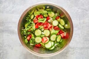 Traditional Greek Salad ingredients in a large bowl.