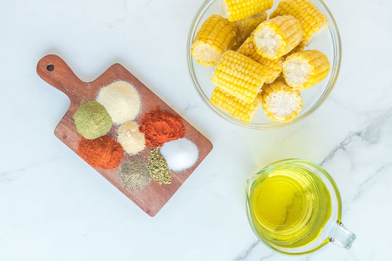 Copycat Wingstop cajun fried corn ingredients on a marble surface.