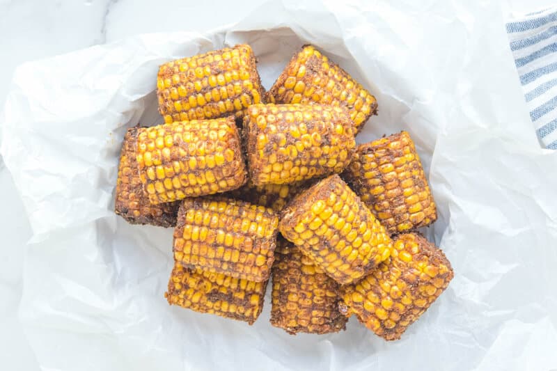 Overhead view of copycat Wingstop cajun fried corn on parchment paper.