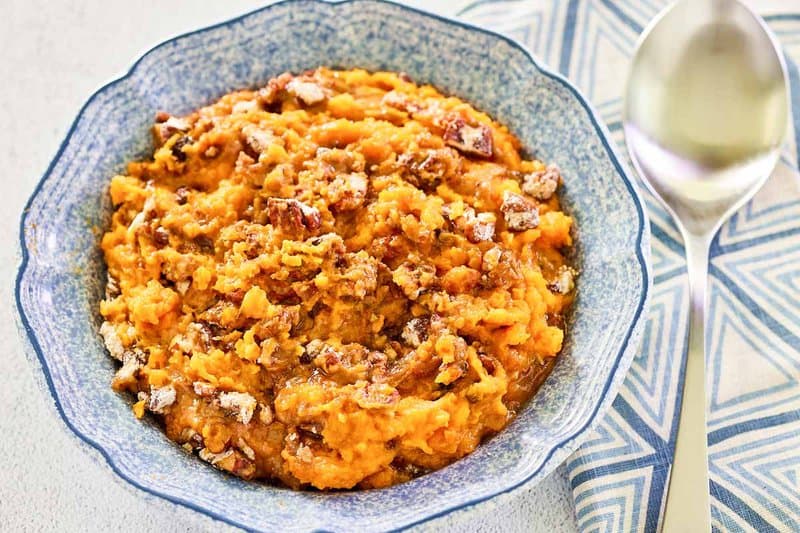 Copycat Burbank's sweet potato casserole in a bowl and a spoon next to it.