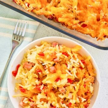 Overhead view of cheesy hash brown casserole in a baking dish and on a plate.