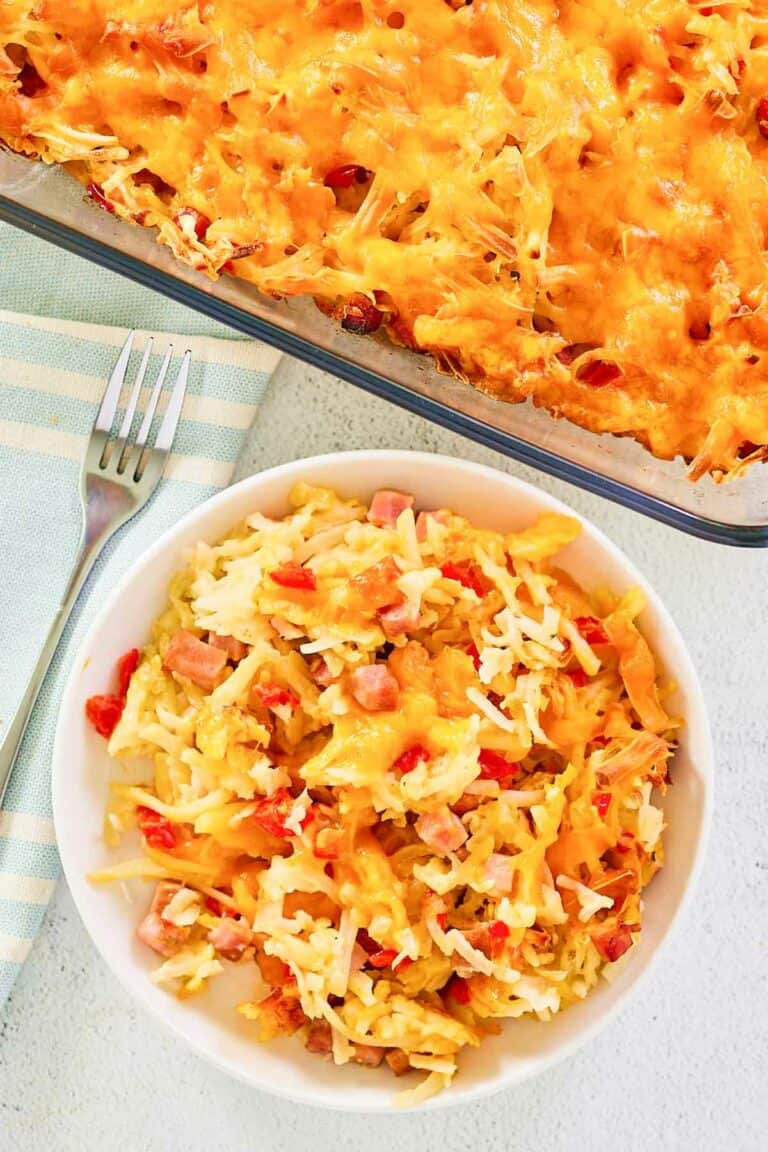 Overhead view of cheesy hash brown casserole in a baking dish and on a plate.