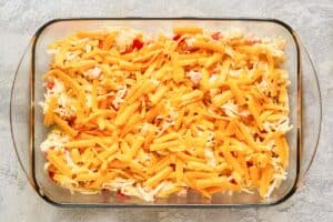 Cheesy hash brown casserole with ham before baking.