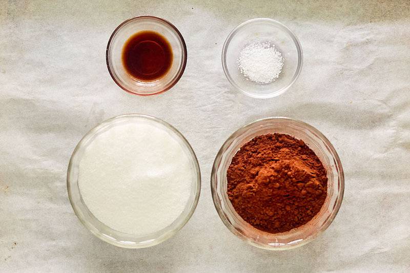 Ingredients for homemade chocolate syrup in small bowls.