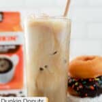 Homemade Dunkin iced coffee and three donuts stacked beside it.