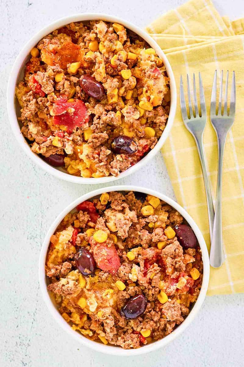 Overhead view of hamburger corn casserole in two bowls.