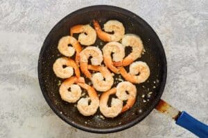 Cooked shrimp in a skillet.