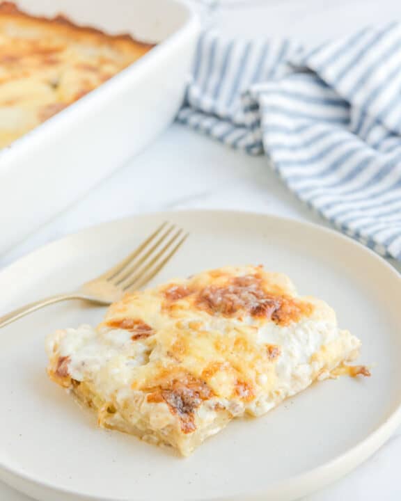 Potato au gratin on a plate and in a baking dish.