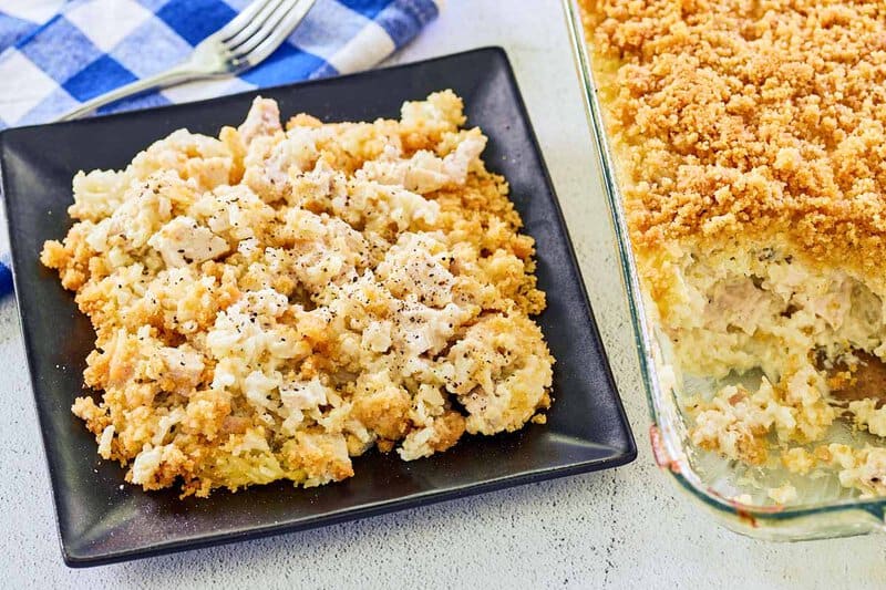 Ritz cracker chicken casserole on a plate next to the casserole in a glass baking dish.