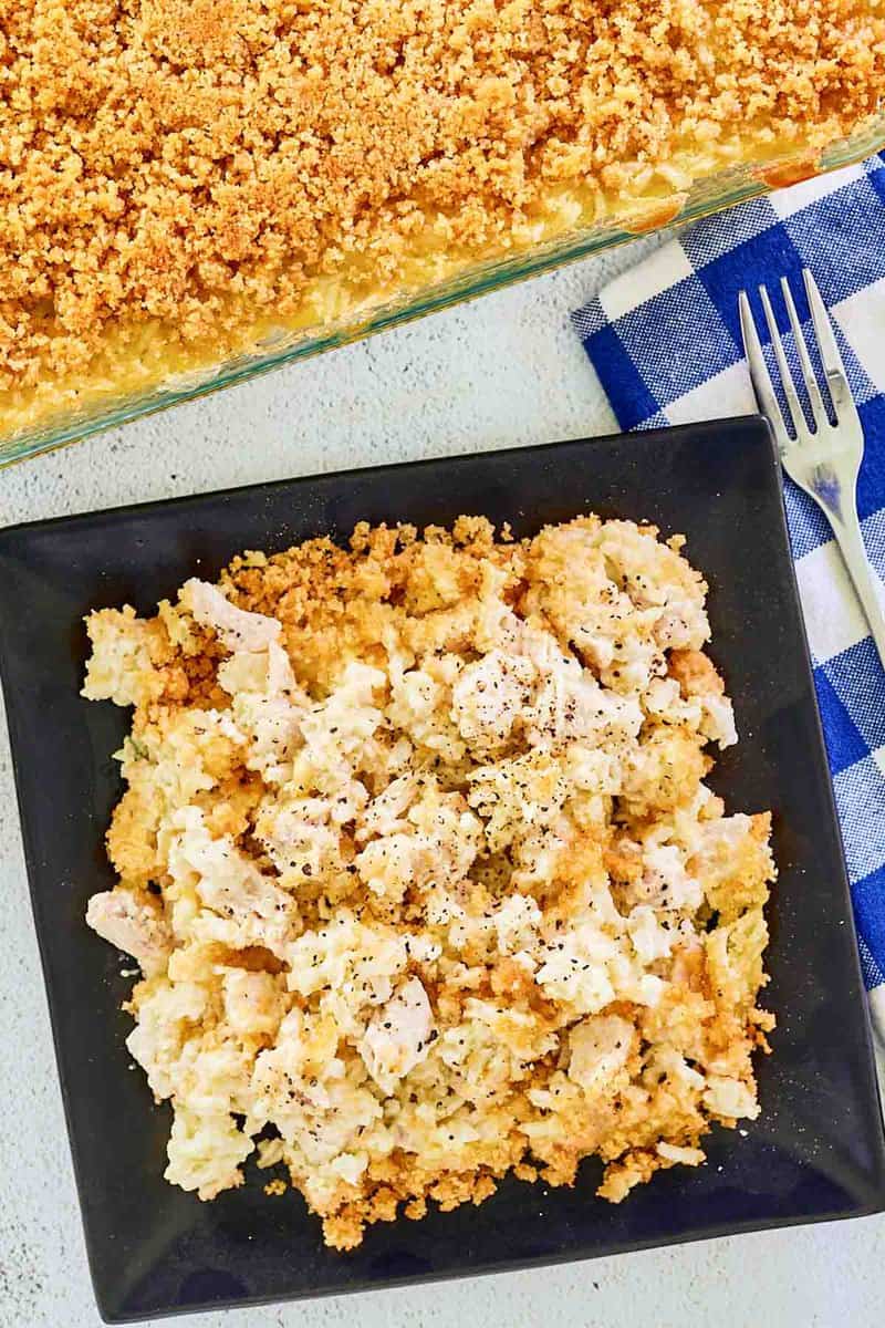 Overhead view of Ritz cracker chicken casserole in a baking dish and a serving on a plate.