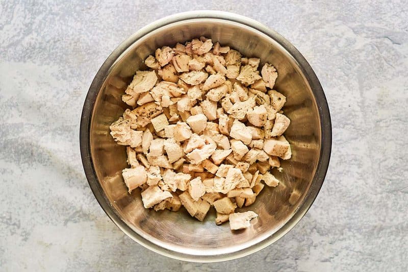 Diced cooked chicken in a mixing bowl.