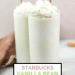 Two homemade Starbucks vanilla bean frappuccino drinks with whipped cream on top.