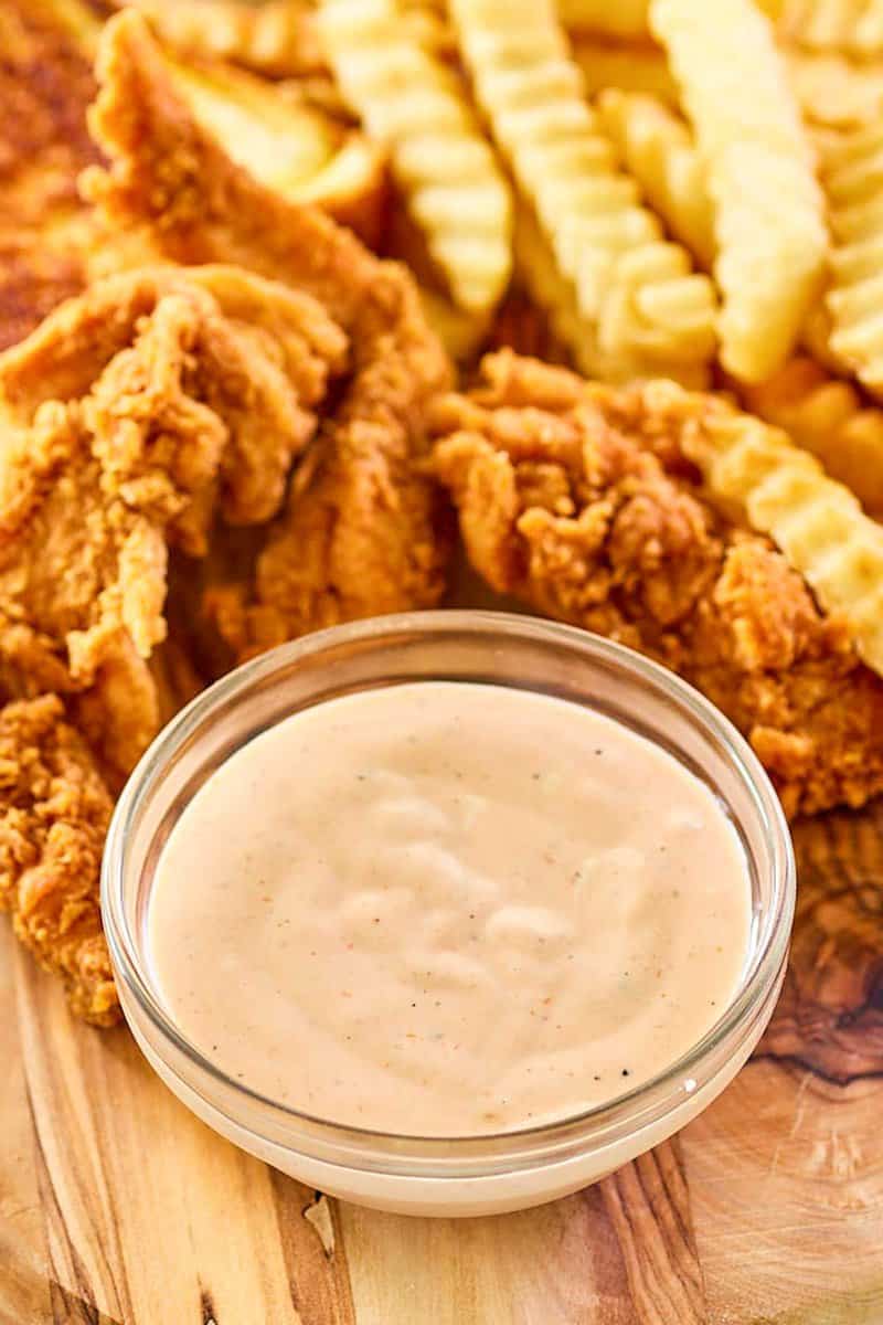 Copycat Zaxby's zax sauce, fried chicken fingers, and crinkle-cut fries.