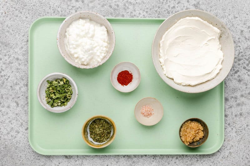 Homemade boursin cheese ingredients on a tray.