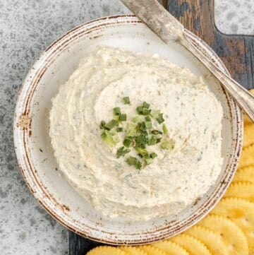 Overhead view of homemade boursin cheese and crackers next to it.