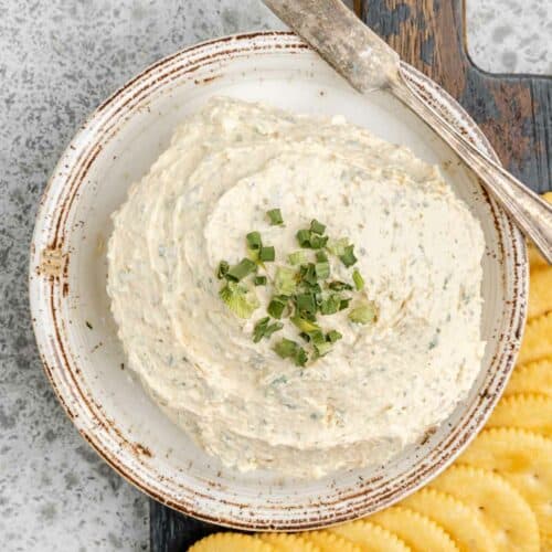 Overhead view of homemade boursin cheese and crackers next to it.