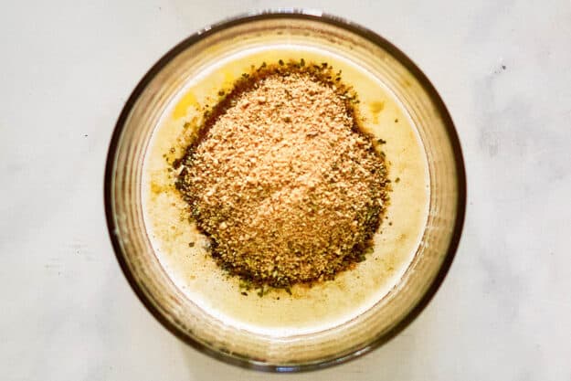 Bread crumbs and melted butter in a bowl.