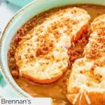 Closeup of homemade Brennan's French onion soup in a blue bowl.