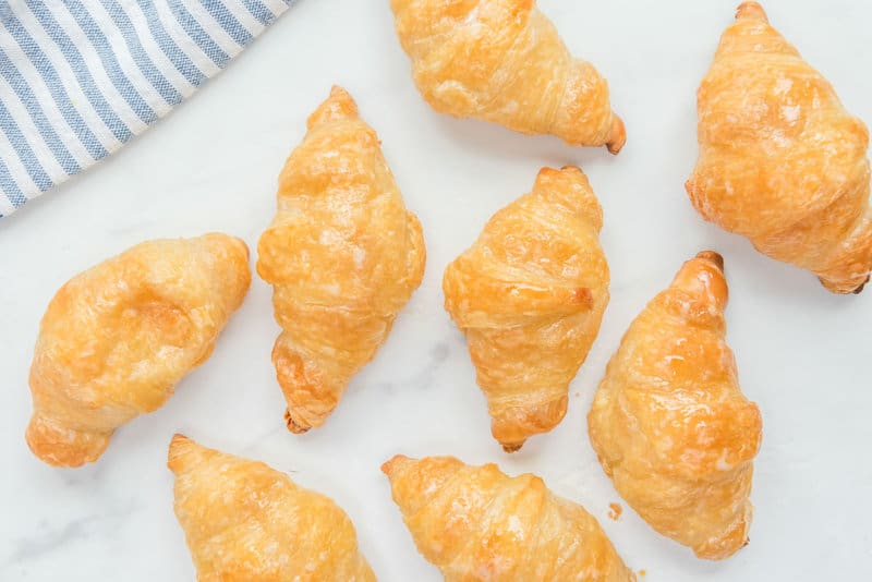 Copycat Cheddar's honey butter croissants on a marble surface.