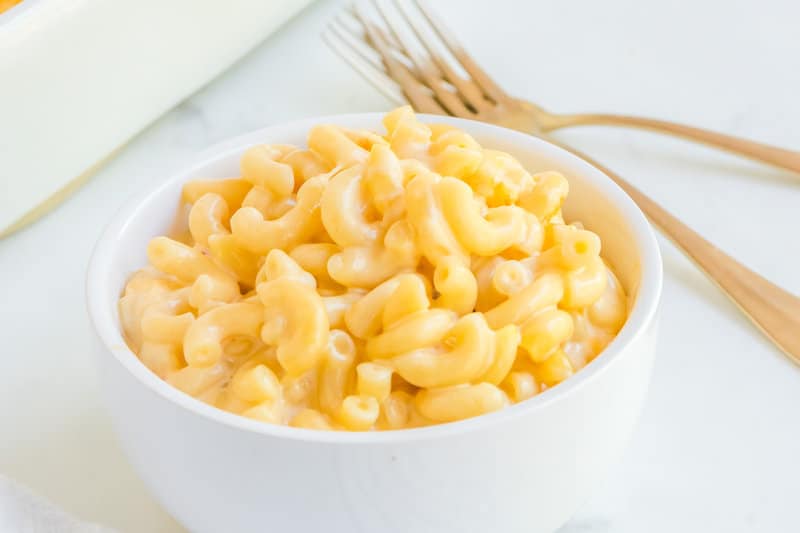 A bowl of copycat Chick Fil A mac and cheese and two forks.