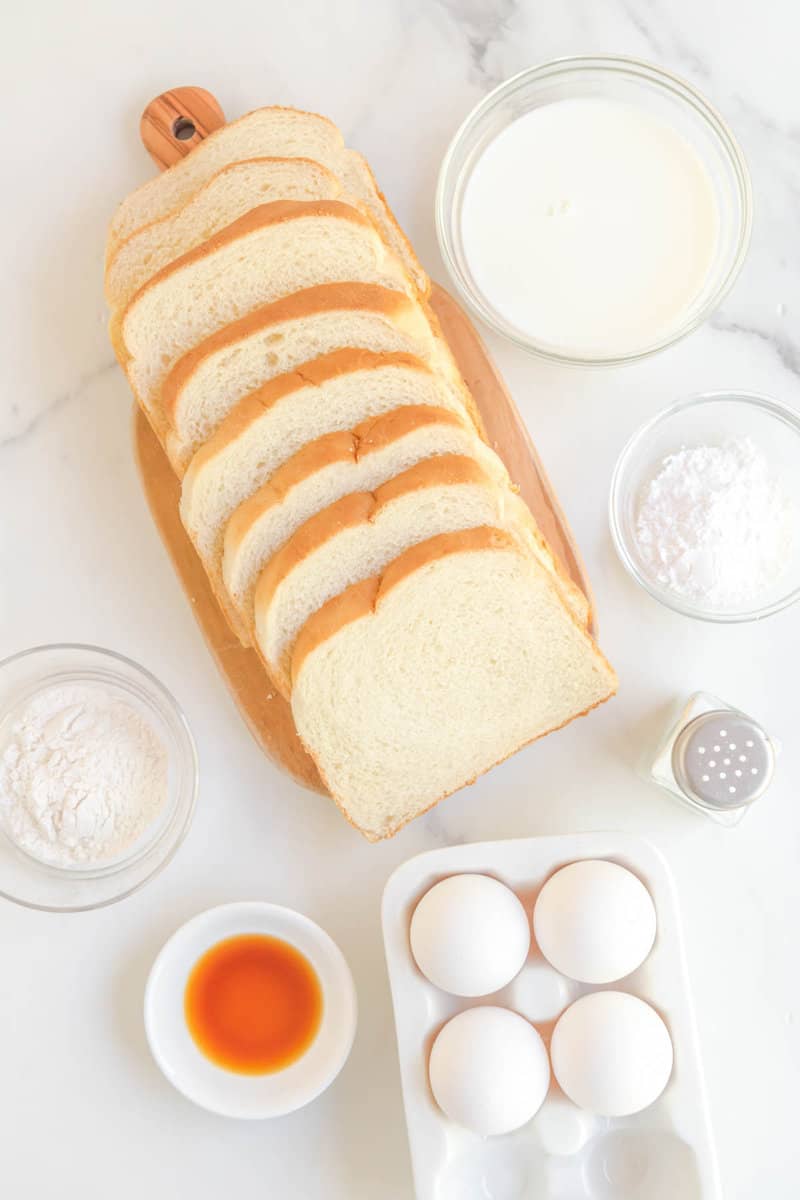 Copycat Cracker Barrel French toast ingredients connected  a marble surface.