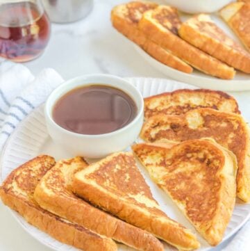 Copycat Cracker Barrel French toast and a bowl of syrup on a plate.