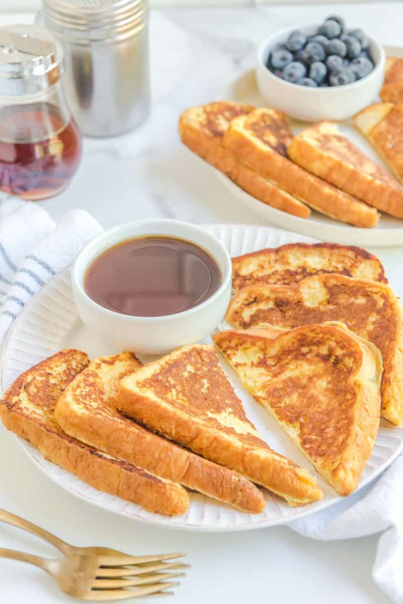 Copycat Cracker Barrel French toast and a bowl of syrup on a plate.