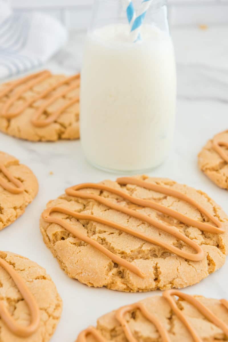 Copycat Crumbl ultimate peanut butter cookies and a glass of milk.