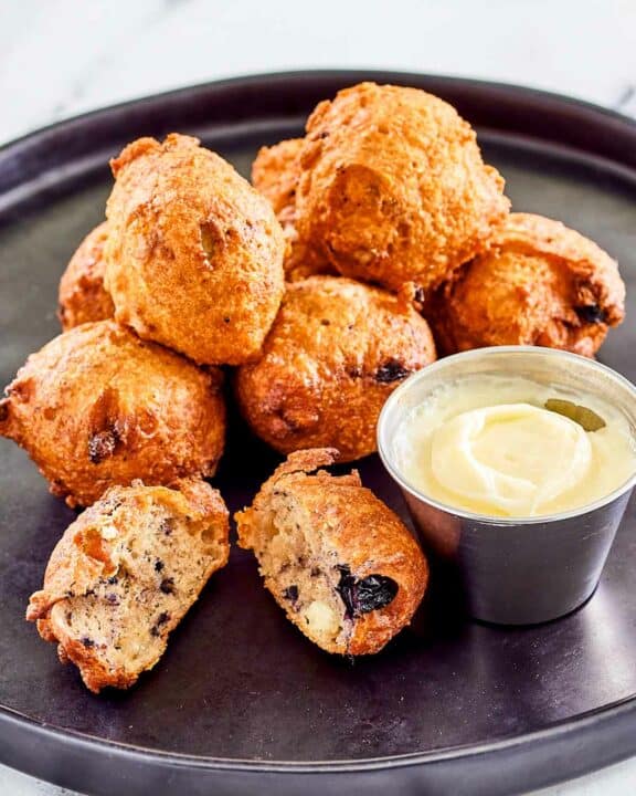 Copycat Denny's blueberry pancake puppies and cheesecake dip on a plate.
