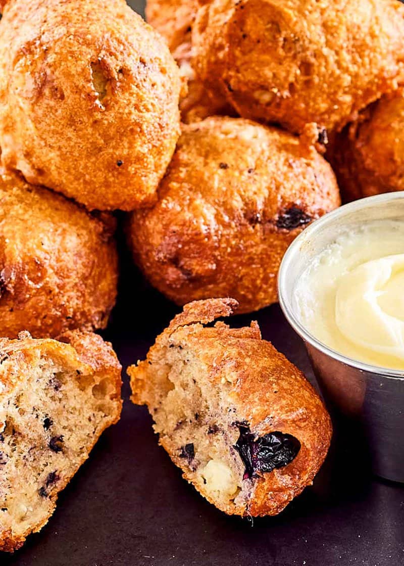 Closeup of copycat Denny's blueberry pancake puppies with cheesecake dip.