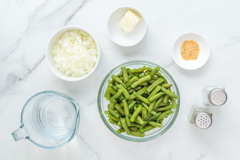 Copycat KFC green beans ingredients on a marble surface.