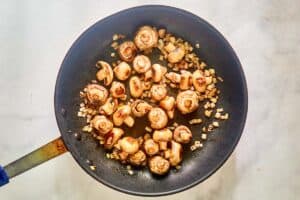 Butter sauteed mushrooms and onions in in a skillet.