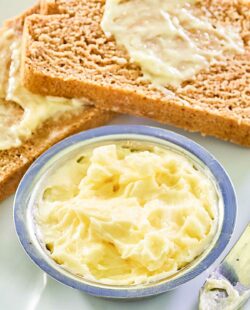 Copycat Saltgrass Steakhouse honey butter in a bowl and on bread slices.