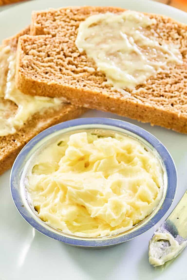 Copycat Saltgrass Steakhouse honey butter in a bowl and on bread slices.
