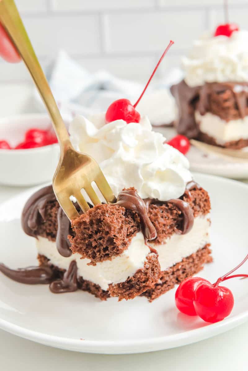 Copycat Shoney's hot fudge cake on a plate and a fork.