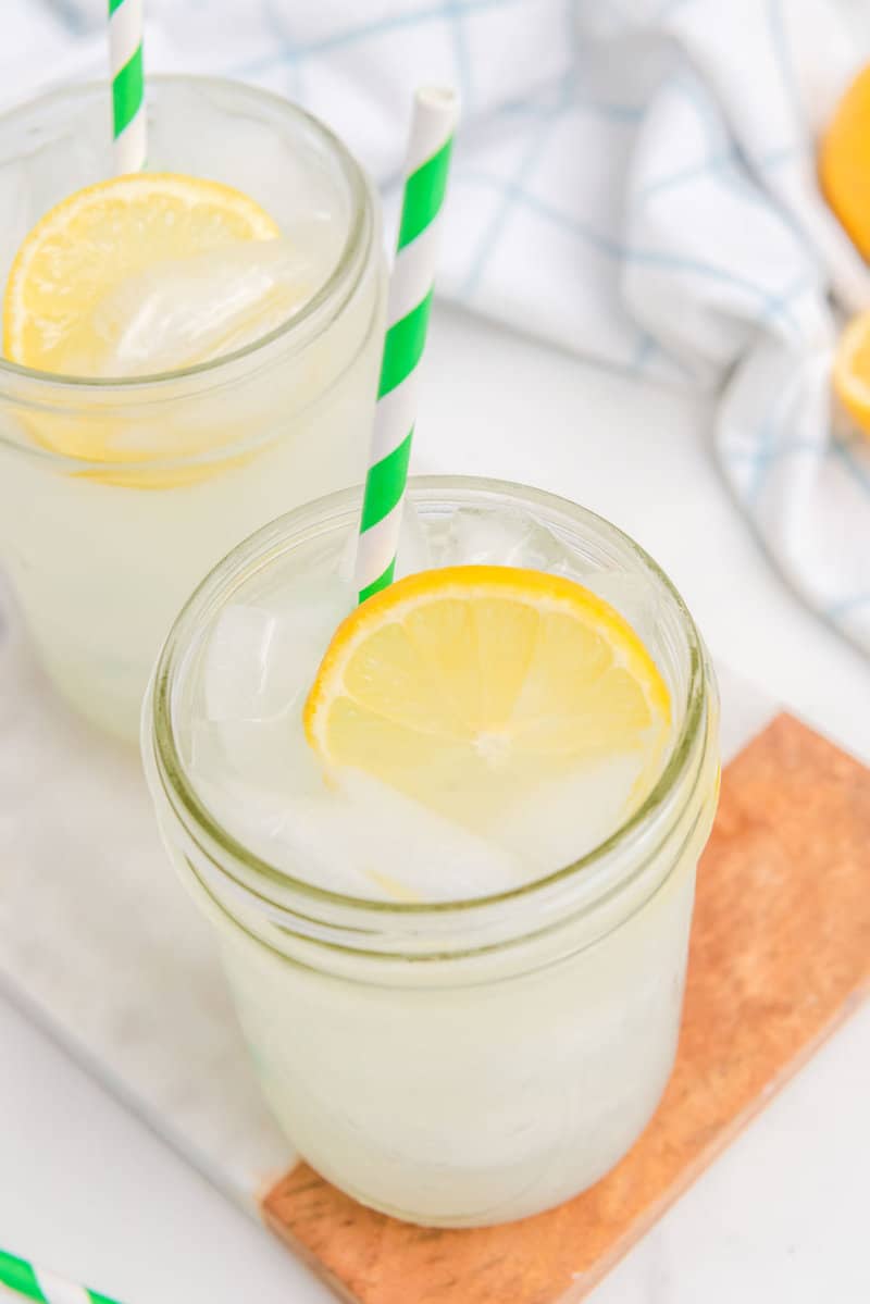 Copycat Starbucks lemonade in mason jars with a fresh lemon slice.
