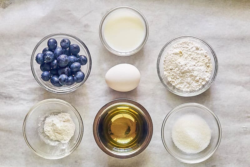 Ingredients for sweet muffins on parchment paper.