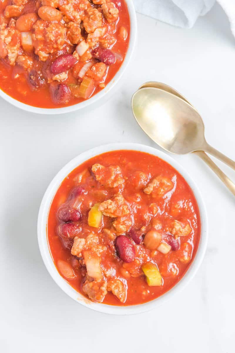 Overhead view of copycat Wendy's chili in two bowls and two spoons.