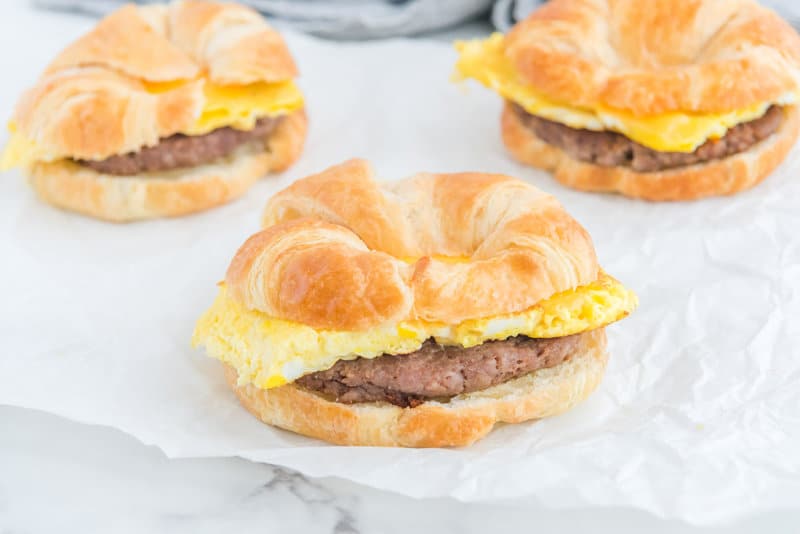 Three copycat Burger King sausage egg and cheese croissant breakfast sandwiches.