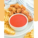 Homemade Chick Fil A Polynesian sauce in a bowl on a plate with nuggets and fries.