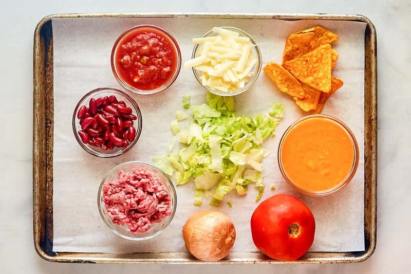 Dorito taco salad ingredients on a tray.