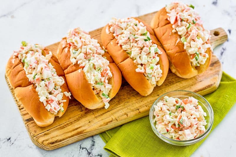 Imitation crab salad in hoagie rolls and a small bowl.
