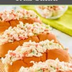 Imitation crab salad in four hoagie buns and a small bowl.