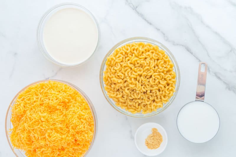 Copycat KFC mac and cheese ingredients on a marble surface.