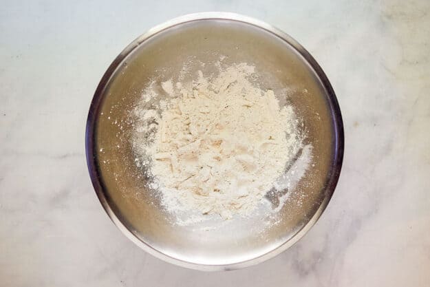 Cheese and flour combined together in a bowl.