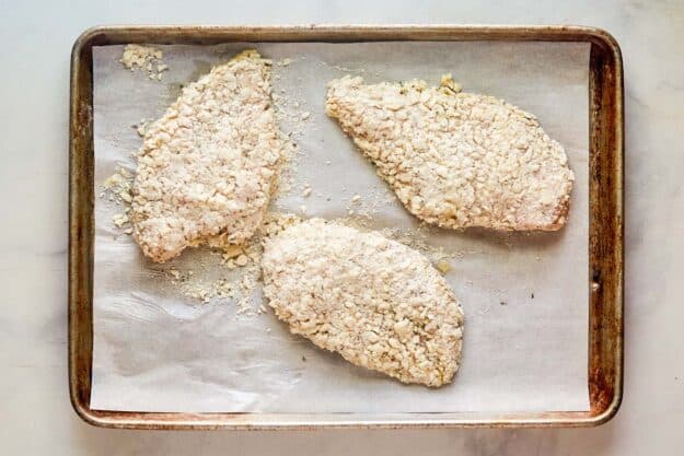 Italian cheese breaded chicken breasts on a tray.