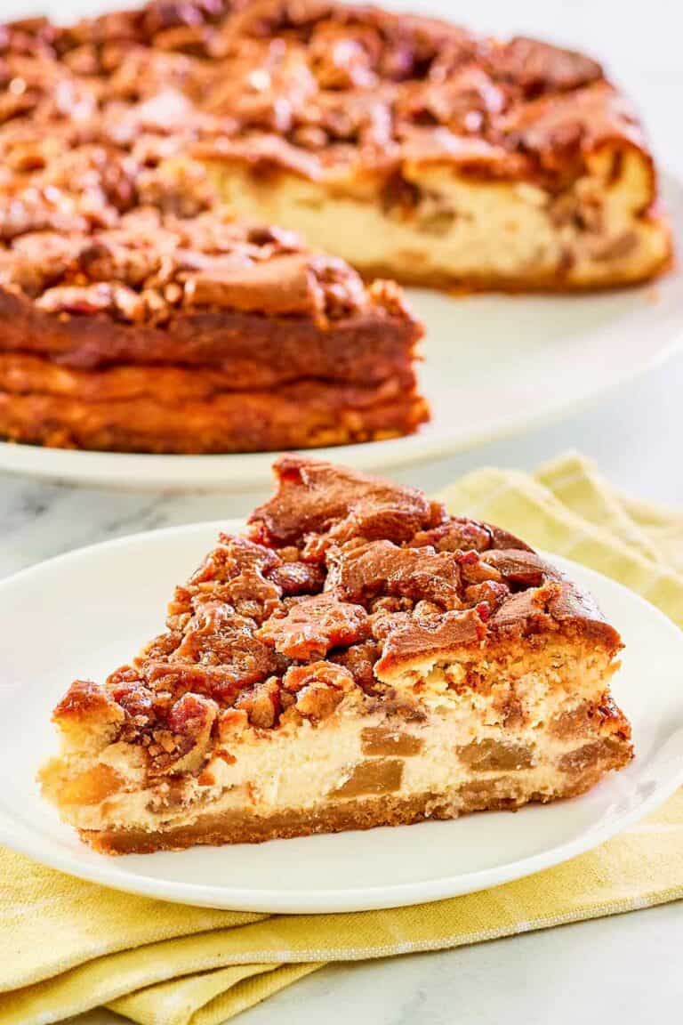 Copycat Olive Garden apple praline cheesecake on a plate and the cheesecake behind it.