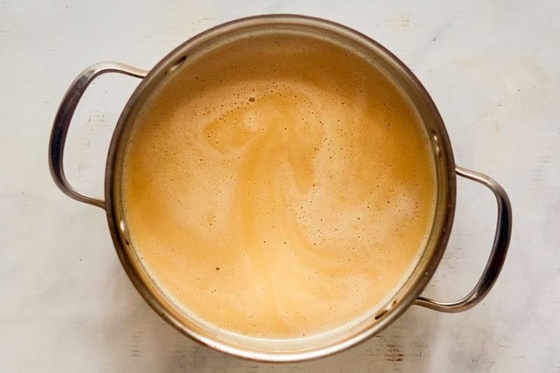 Homemade sweet hot mustard mixture in a saucepan.